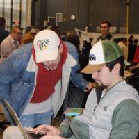 two people looking at a laptop